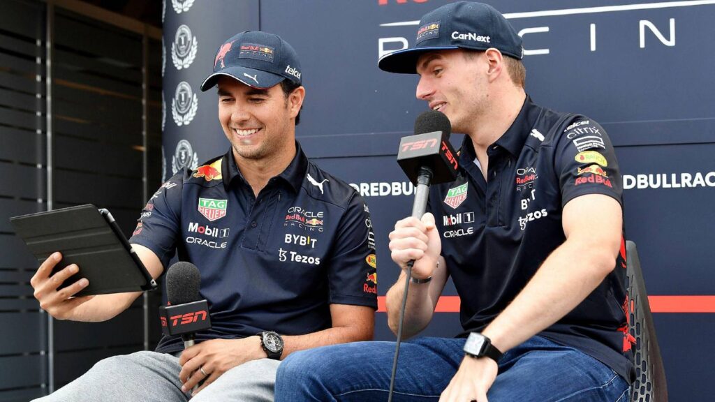 Max Verstappen and Sergio Perez looking at an iPad planetF1